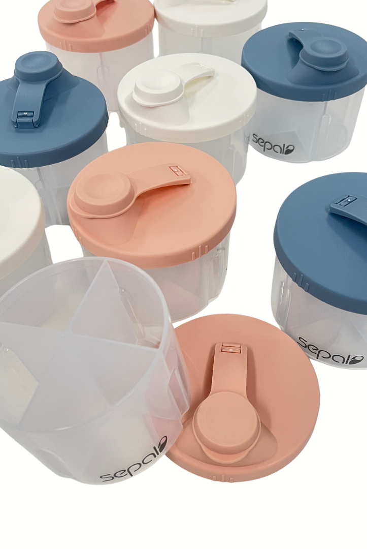 Set of plastic containers with colorful lids on a white background