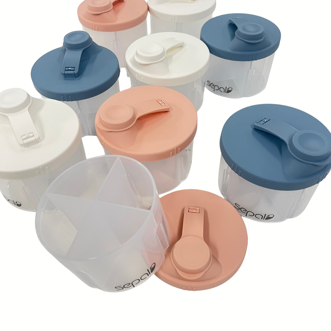 Set of plastic containers with colorful lids on a white background