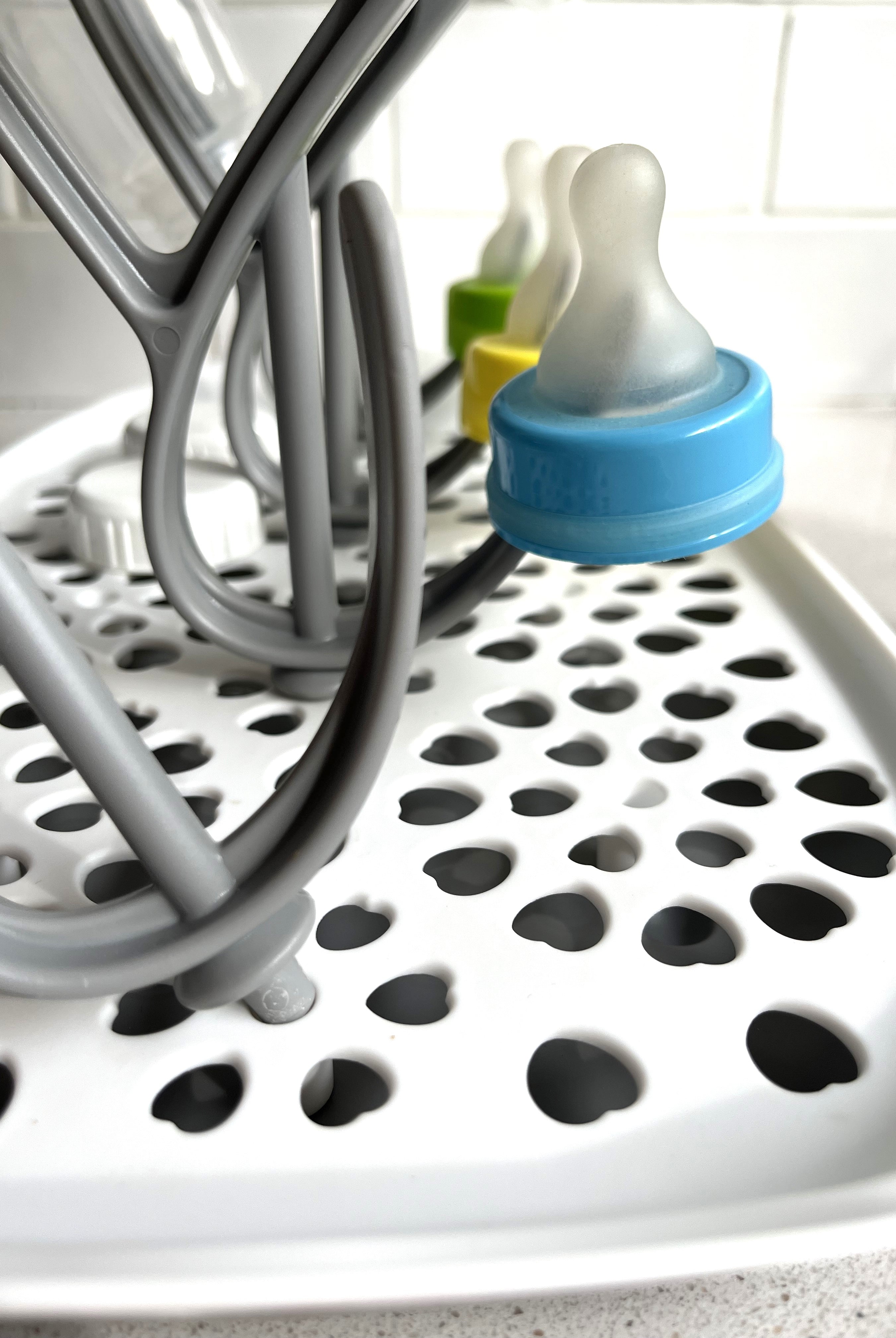 3 different Sepal teats and some Sepal white caps on the Sepal bottle & teat drying rack.
