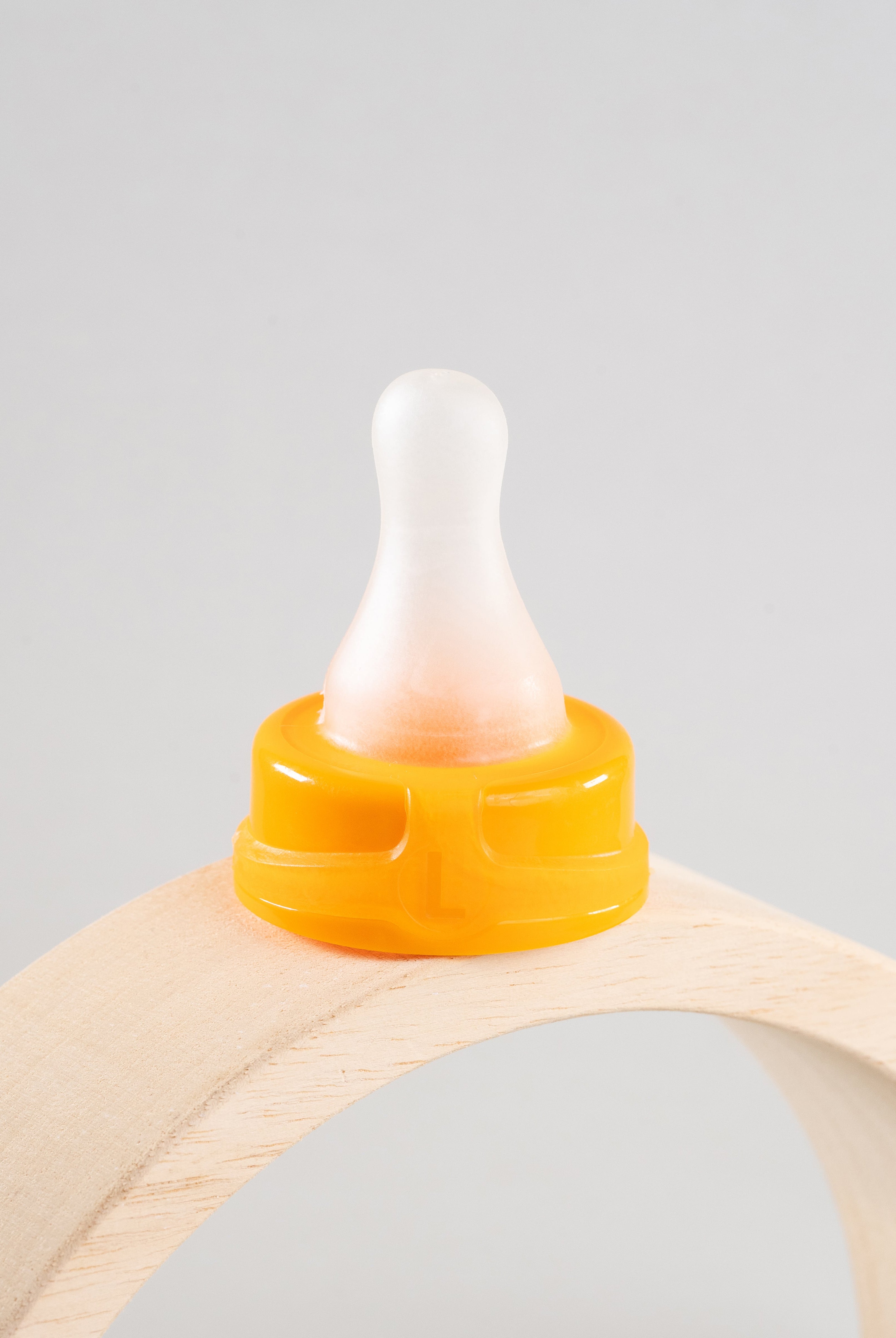 Sepal orange large teat fast flow displayed on a wooden arch