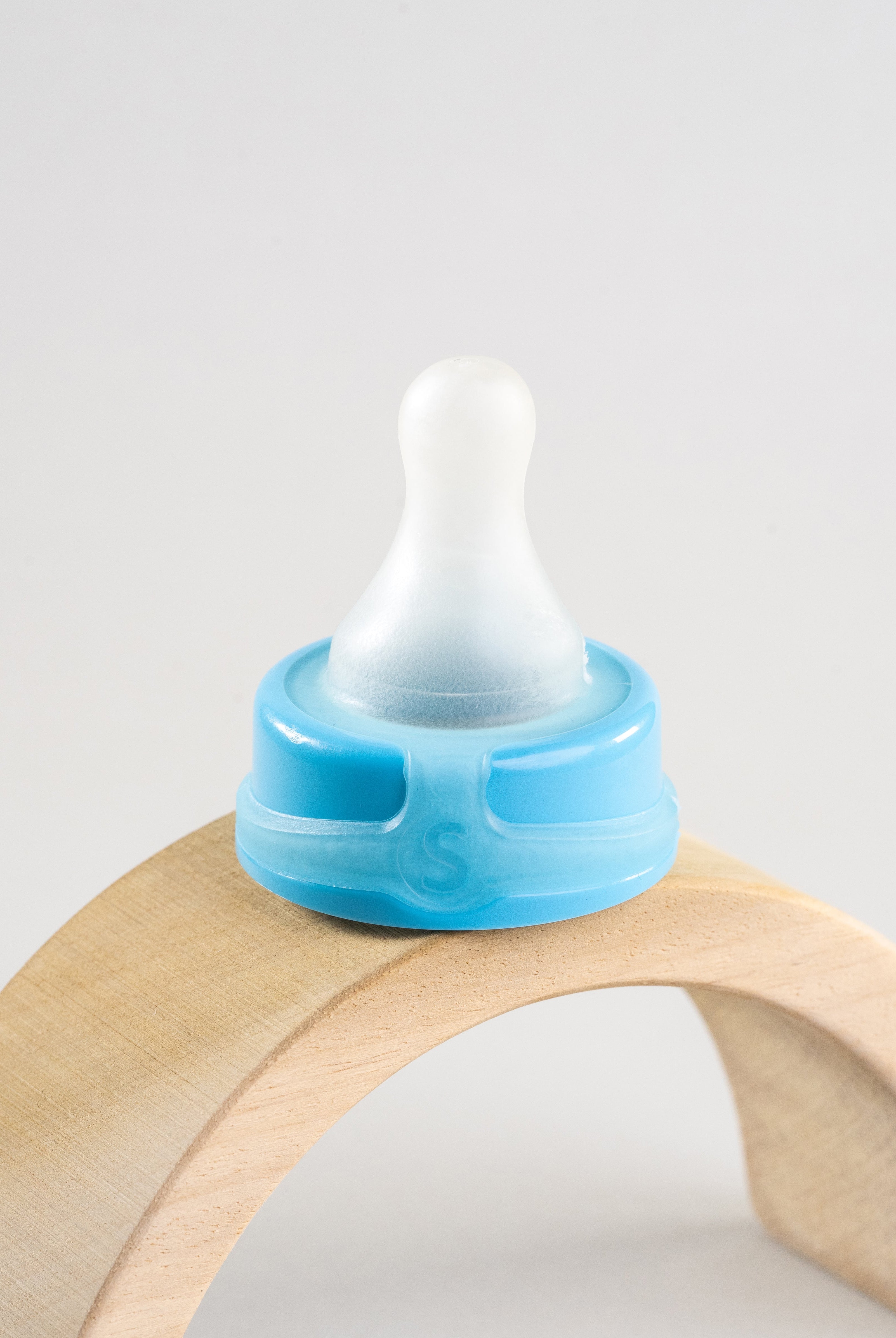 Sepal blue small teat extra slow flow displayed on a wooden arch