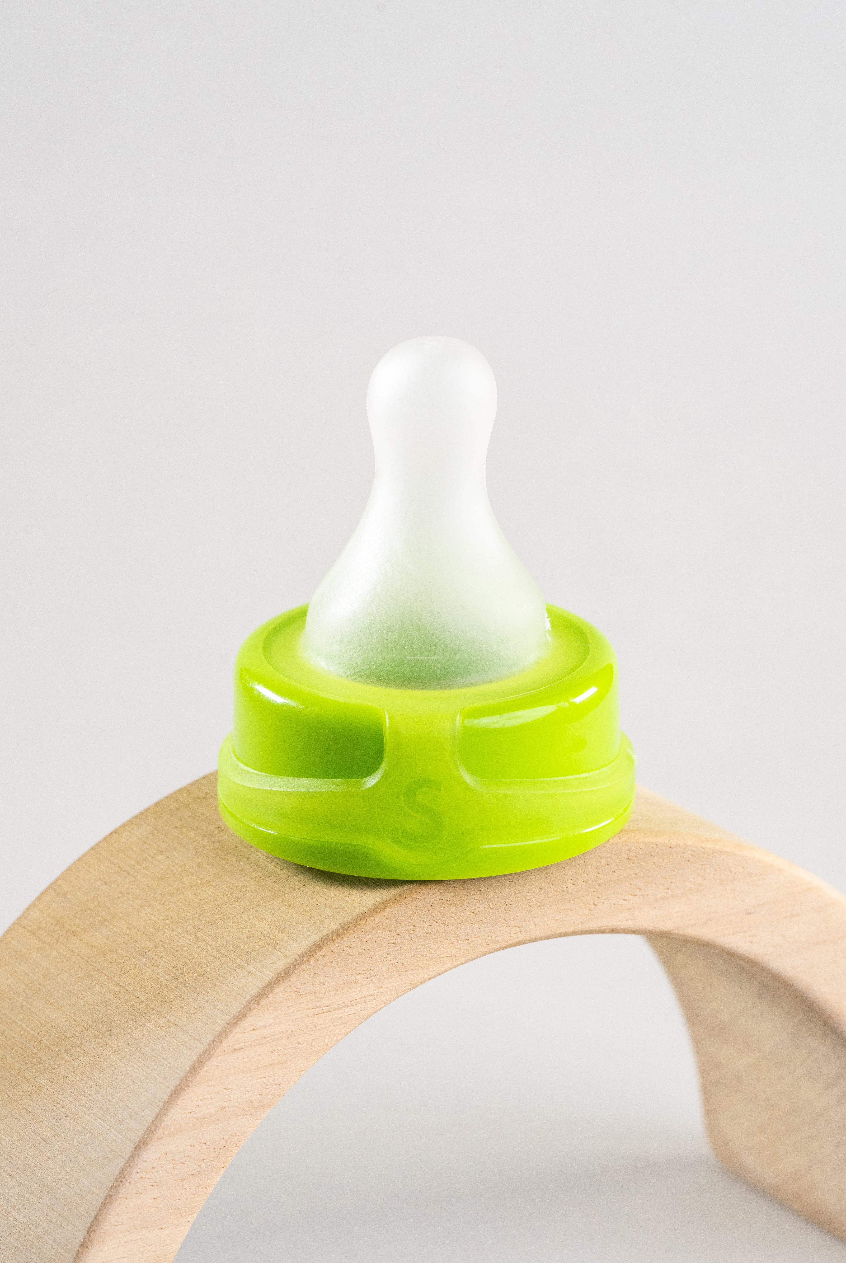 Sepal green small teat slow flow displayed on wooden arch.