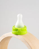 Sepal green medium teat slow flow displayed on wooden arch.