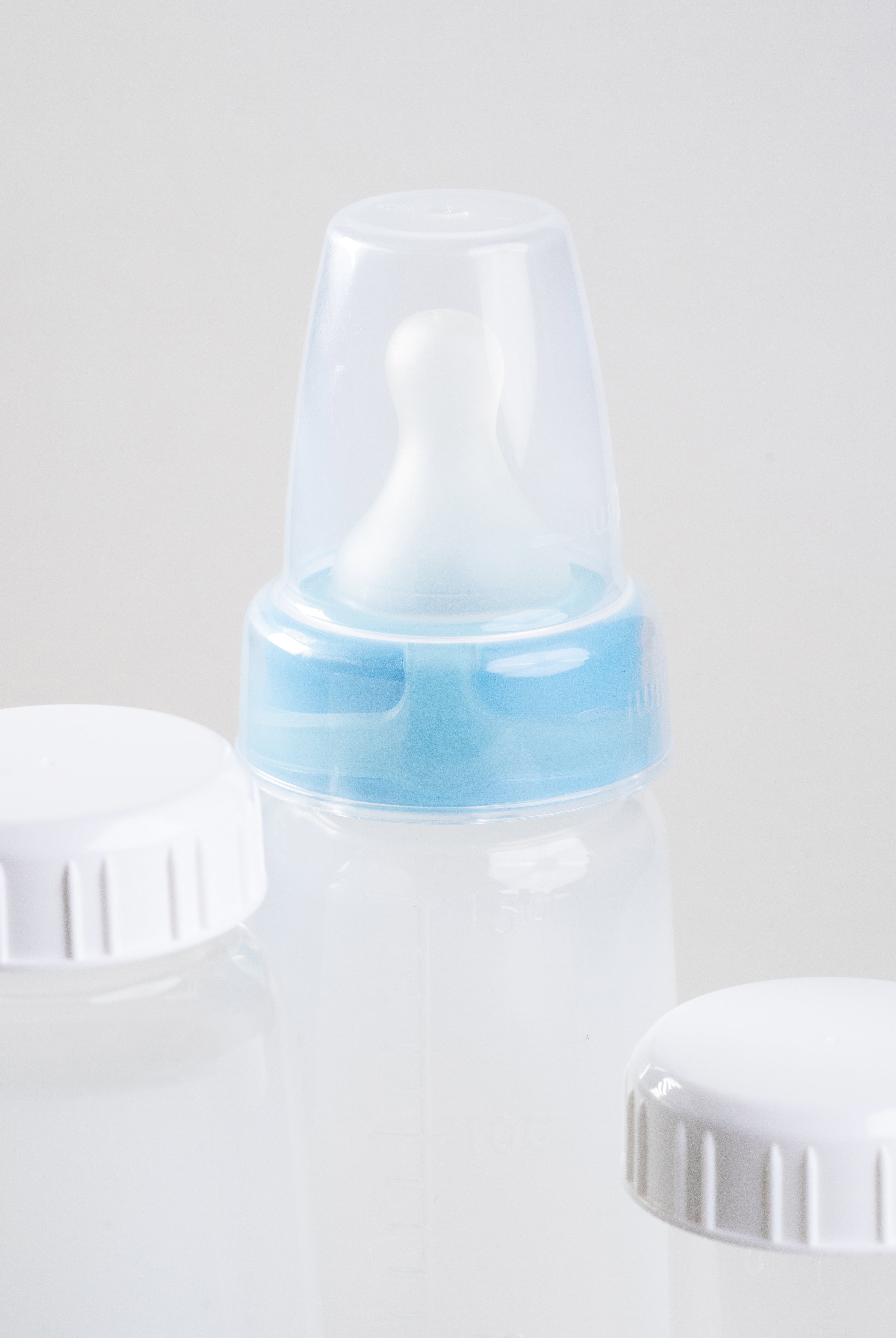 close up of some sepal items in the extra small store and feed pack. 2 Sepal white caps, 1 sepal clear teat cover, 1 sepal blue extra small extra slow flow, 3 sepal 150ml bottles.