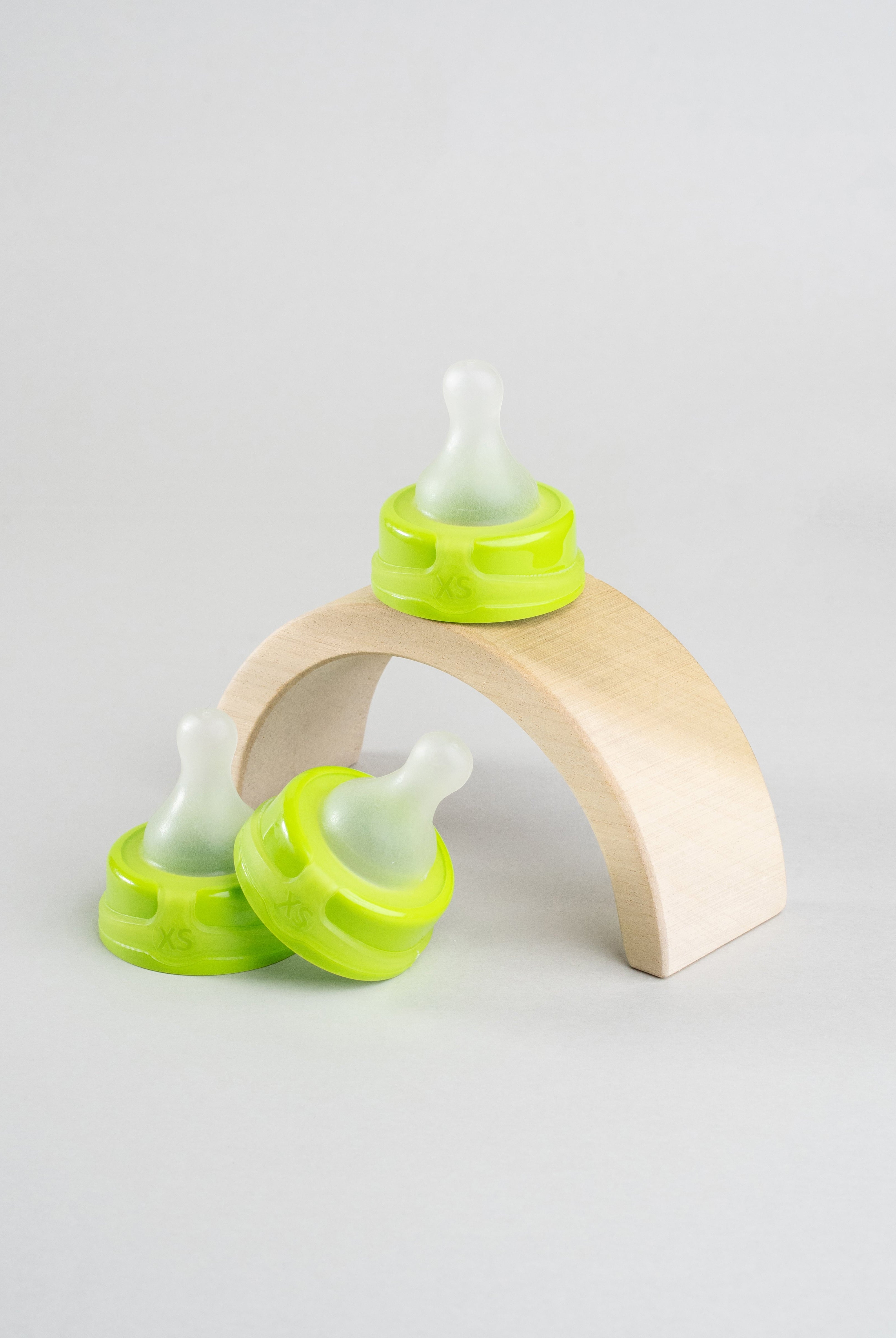 3 Sepal green extra small slow flow teats. Displayed on a wooden arch.