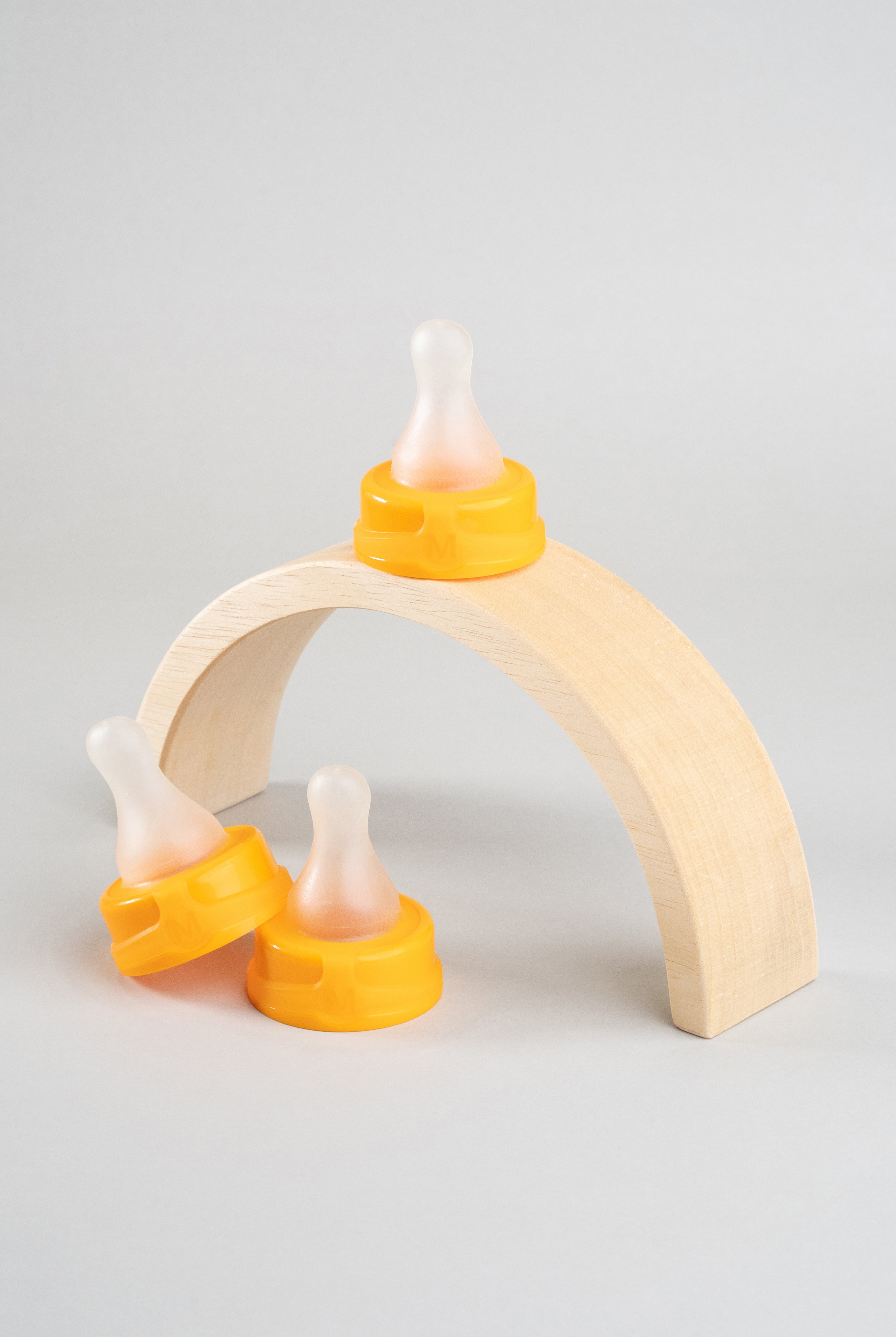 3 Sepal orange medium teat fast flow displayed on a wooden arch.