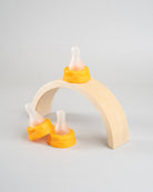 3 Sepal orange medium teat fast flow displayed on a wooden arch.