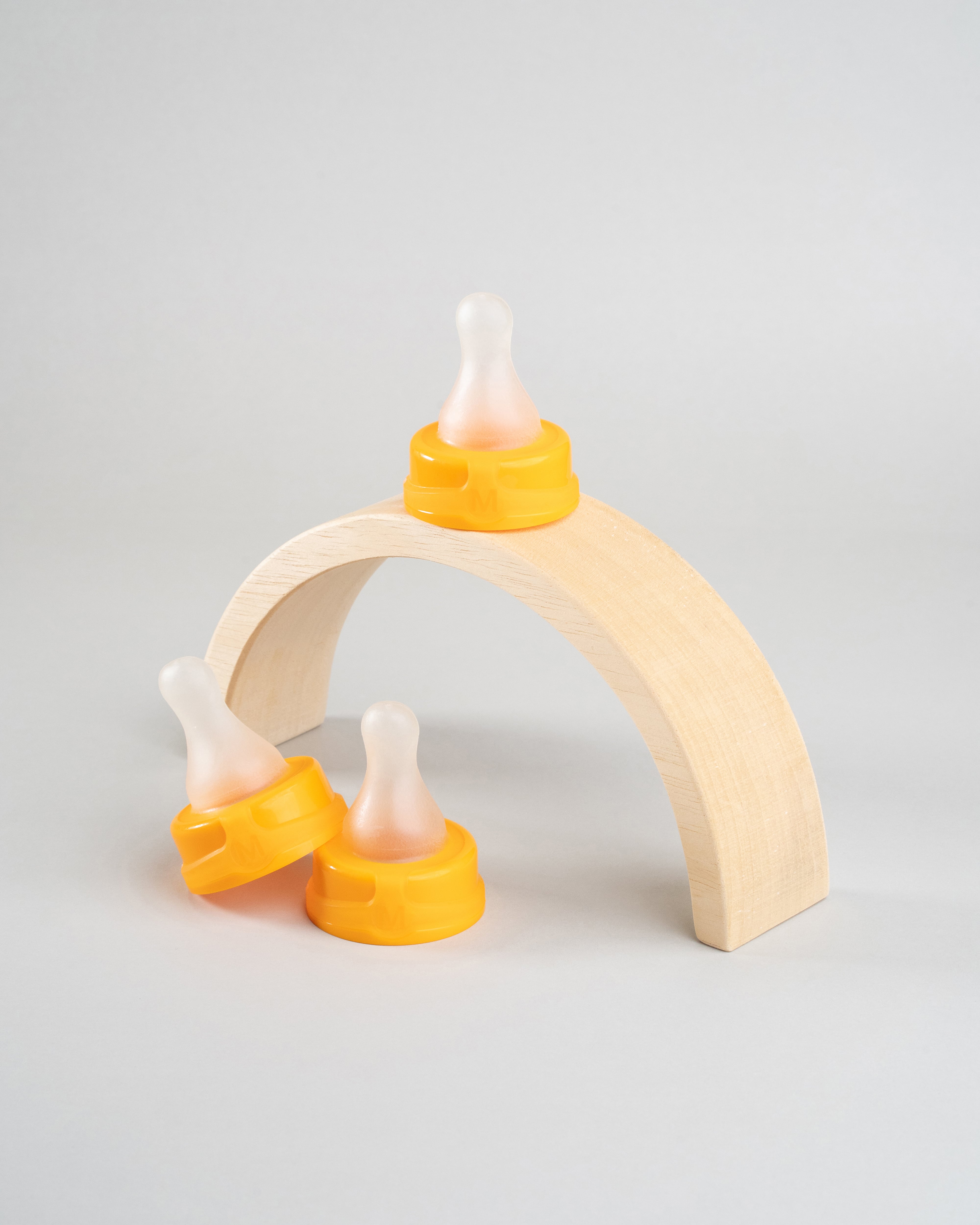 3 Sepal orange medium teat fast flow displayed on a wooden arch.