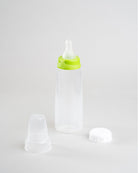 Sepal 250ml bottle with green small teat slow flow attached. Beside this is a Sepal white cap and a clear Sepal Teat Cover.