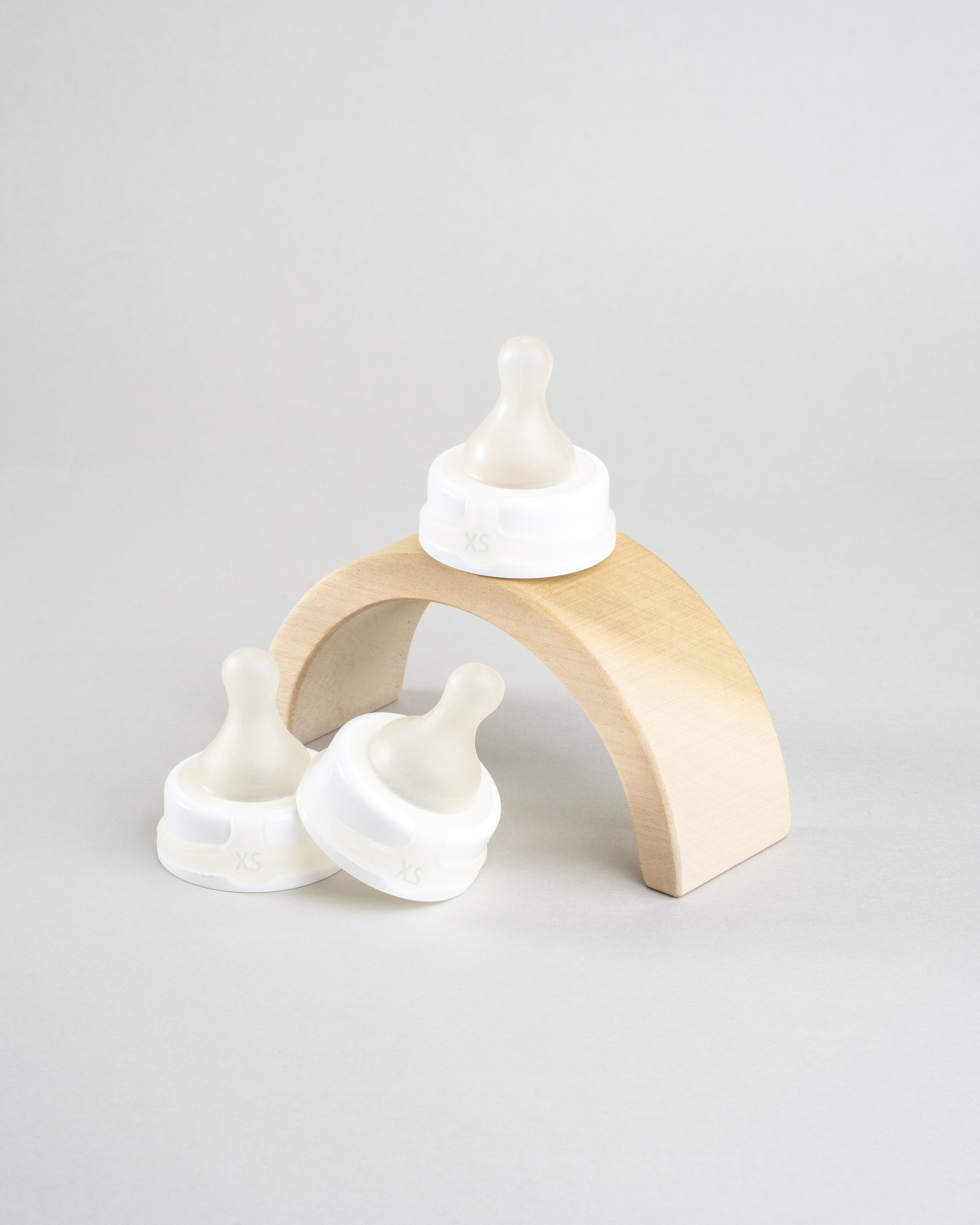 3 Sepal white extra small ultra slow flow teats. Displayed on a wooden arch.