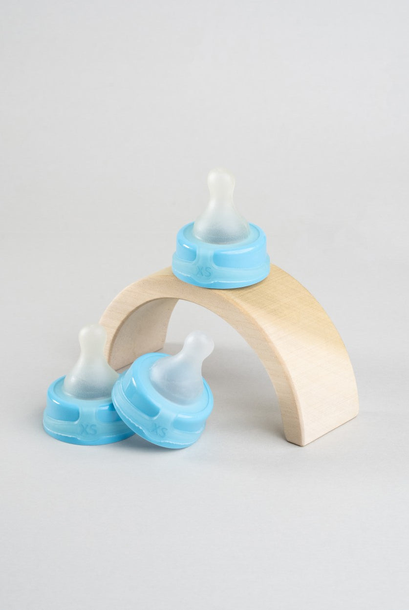 3 Sepal blue extra small extra slow flow teats displayed around a wooden arch.