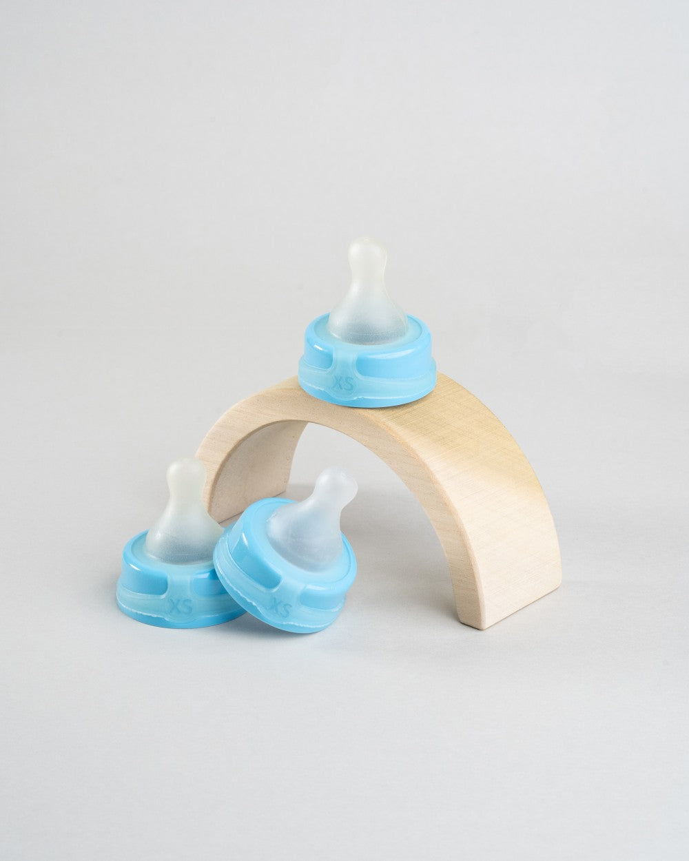 3 Sepal blue extra small extra slow flow teats displayed around a wooden arch.