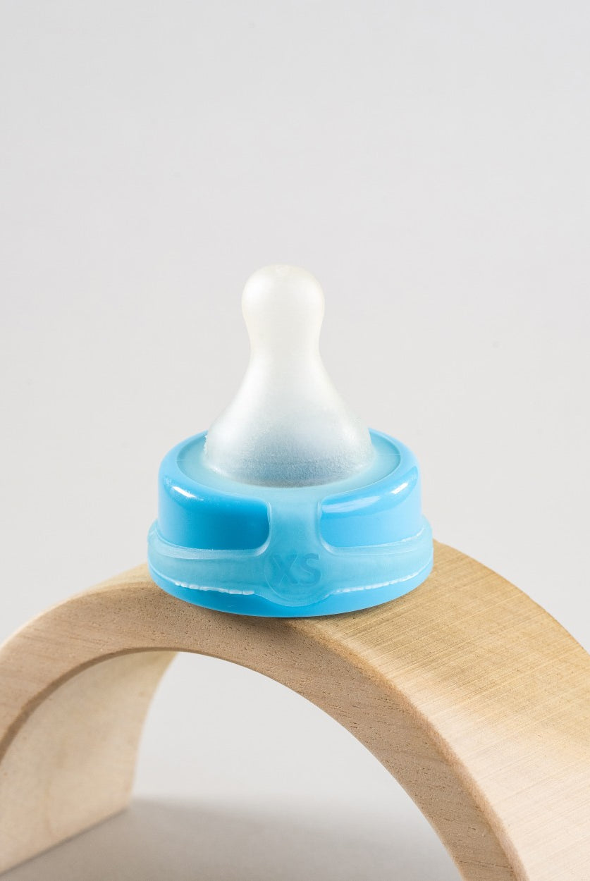 Sepal blue extra small extra slow flow teat displayed on a wooden arch.