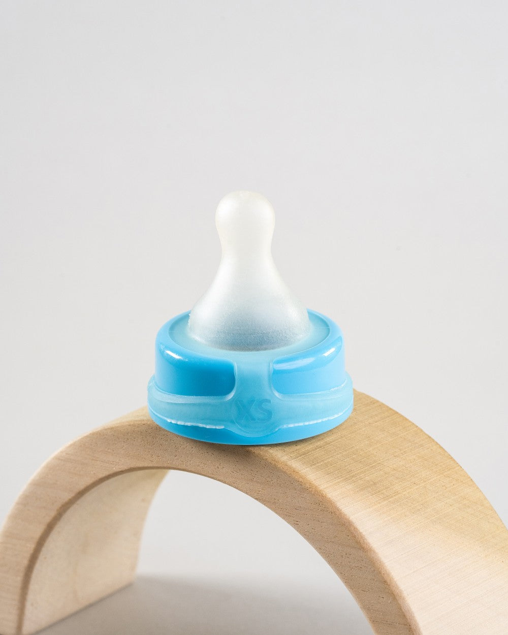 Sepal blue extra small extra slow flow teat displayed on a wooden arch.