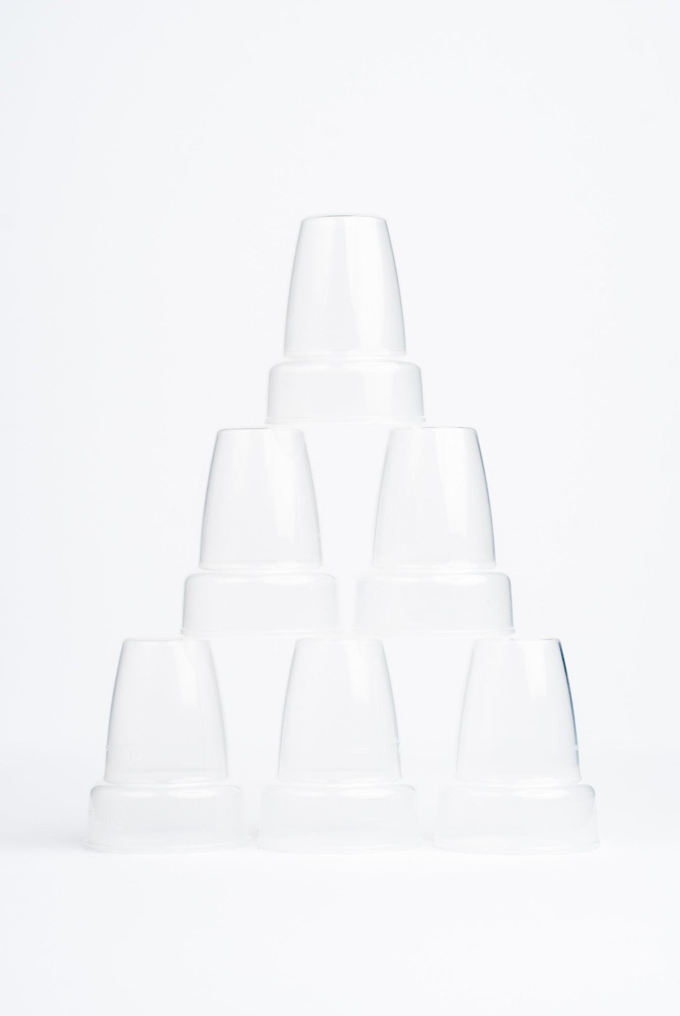6 clear sepal teat covers stacked in a pyramid