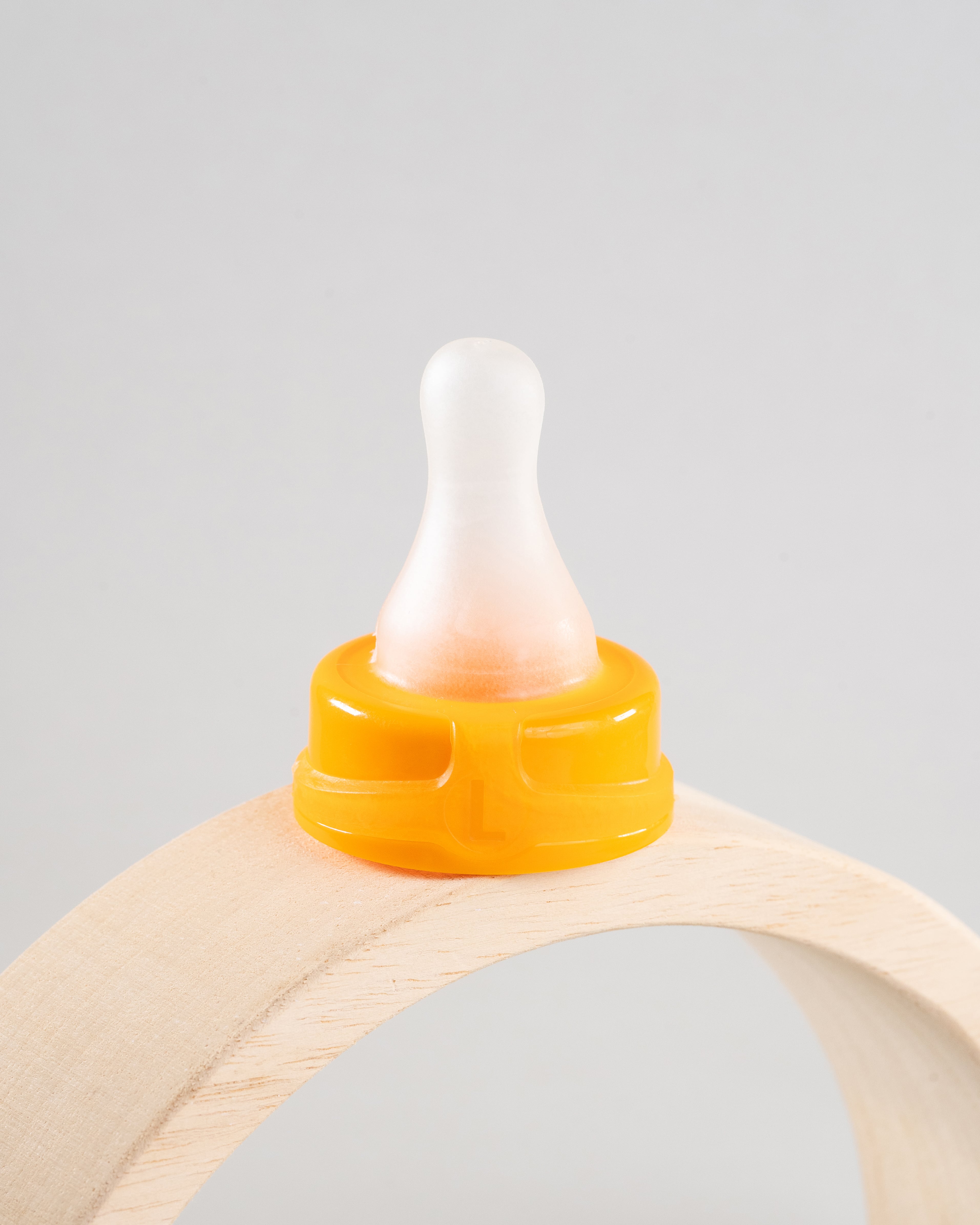 Sepal orange large teat fast flow displayed on a wooden arch